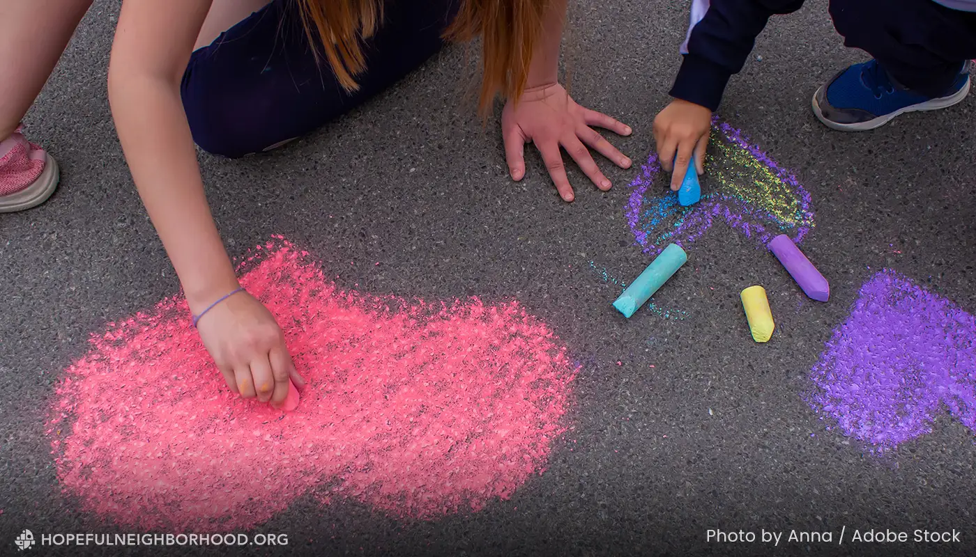 Girls drawing on street with chalk