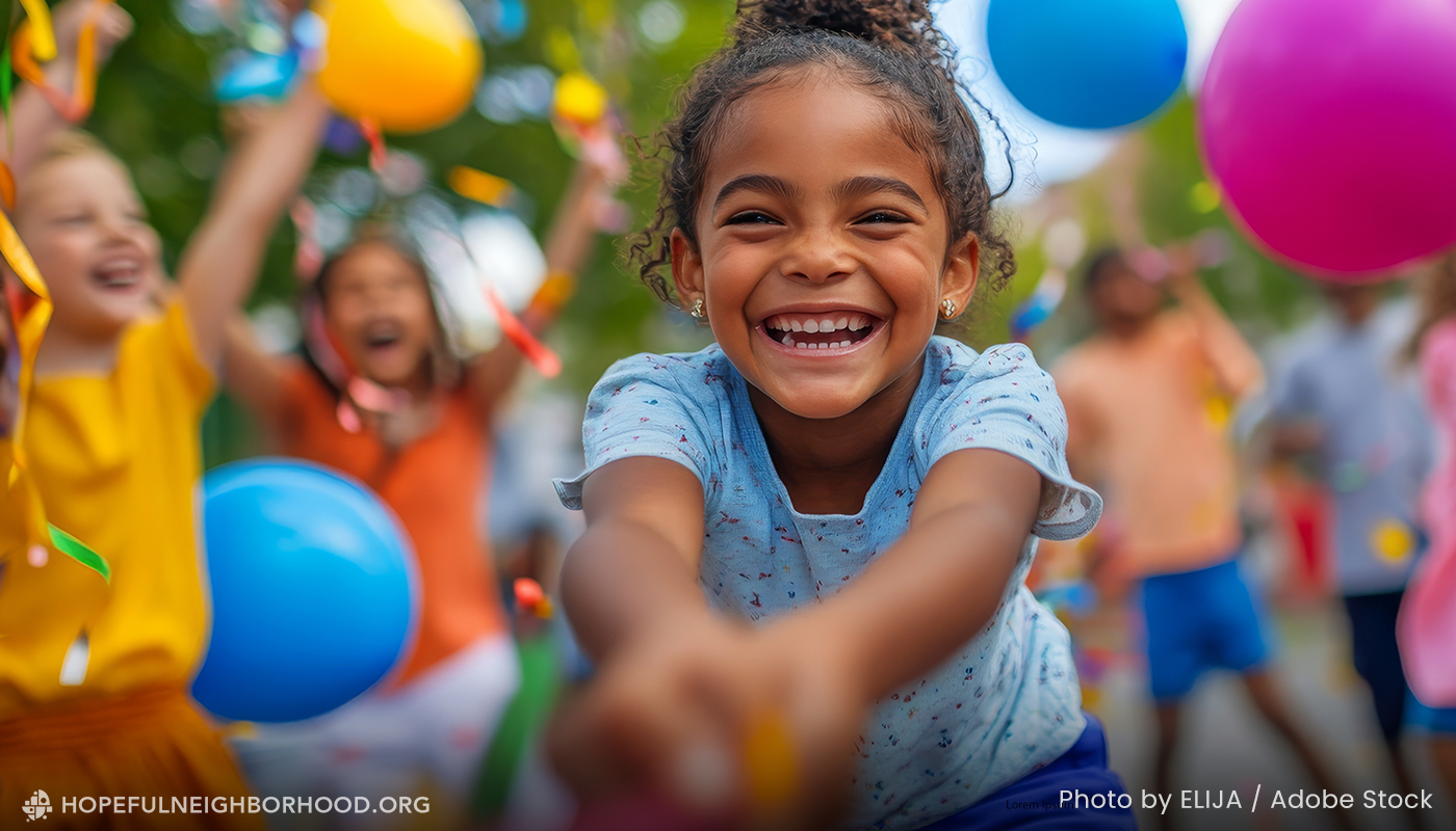 An adorable girl playing with other kids at a block party